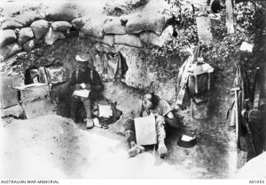 Two soldiers sitting in the 11th Battalion's Commanding Officer's dugout, Gallipoli. Image courtesy Australian War Memorial.