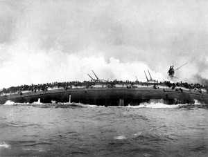 SMS Blucher sinks after receiving multiple hits from British warships. View from the deck of the British cruiser HMS Arethusa, 25 January 1915. Image in public domain.