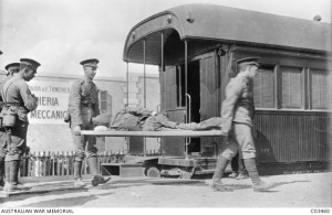 A Turkish prisoner of war, wounded in the unsuccessful attack on the Suez Canal is removed from a hospital train by Australian medical orderlies at Cairo.  Image courtesy Australian War Memorial.