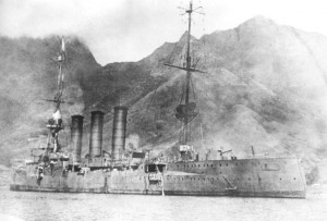 SMS Dresden, flying a white flag, moments before being scuttled. Image in public domain.