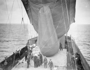 A 'Drachen' type balloon is held steady aboard the SS Manica, as a spotter prepares to climb into the basket, Gallipoli 1915. Image courtesy Imperial War Museum.