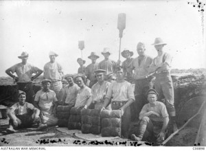 Bakers of the 1st Australian Field Bakery, Imbros, 1915. Four men kneeling in front are displaying newly baked batches of bread. Image courtesy Australian War Memorial.