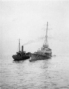 A tug assists the wreck of HMS Arethusa 11 February 1916. Image courtesy Imperial War Museum.
