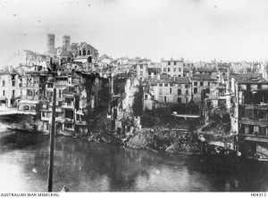 A section of the war damaged city of Verdun as seen from across the Meuse River 1916. Image courtesy Australian War Memorial.