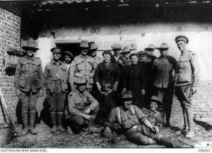 Members of the 1st Battalion outside the house of Madame Bermesch where they are billeted, Nord Pas de Calais, April 1916. Image courtesy Australian War Memorial.