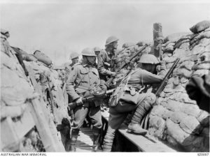 Members of the 2nd Australian Division in the trenches in the Bois Grenier sector, France, 3 June 1916. The soldier in the foreground is looking through a periscope; the man to his left is holding a Lewis gun. Image courtesy Australian War Memorial.