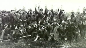 Australian troops celebrate the capture of Pozieres, July 1916, posing as surrendering German soldiers and shouting “mercy, kamerad”. Image courtesy Australian War Memorial.