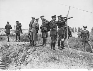 King George V, holding telescope, watches the battle of Pozieres from captured ground, 10 August 1916. The Prince of Wales is behind the King, Ernest Brooks. Image courtesy Australian War Memorial.