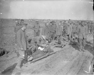 German prisoners and wounded troops of Grenadier Guards are offered cigarettes, Battle of Morval, 25 September 1916. Image courtesy Imperial War Museum © IWM (Q 4303).